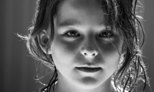 black and white portrait of a little girl with long hair