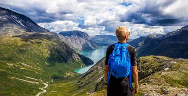 tourist in the mountains of norway on a sunny day