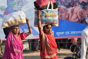 indian women with bags on their heads