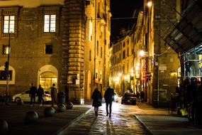 people walking along the road in the night city