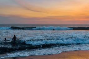 people swim in the ocean in Bali at high tide