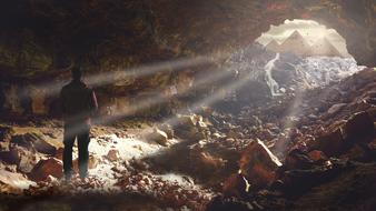 man in Cave Rock at sunLight