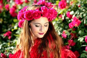 photo of a girl with a wreath of red garden roses