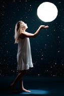 photo of a girl who can touch the moon