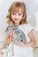 photo of a cute girl with a gray rabbit