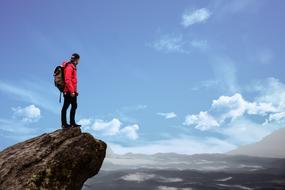 Hiking, man in red on Mountain peak