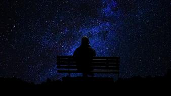 People on bench at Darkness and sky