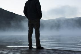 photo of a guy on the background of a foggy lake