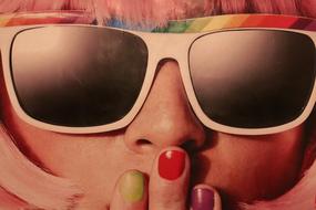 Portrait of the girl with colorful sunglasses and nails, with pink hair