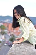 photo of brunette model on the roof of a building
