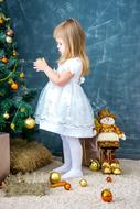 girl decorating Christmas tree