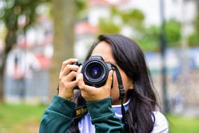 Girl Taking Photo with digital Camera outdoor