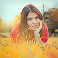 asian woman lying on yellow grass