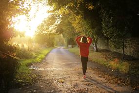 Fitness, Girl walking on path at sunrise