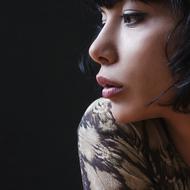 Portrait of the beautiful, brunette girl, blowing lips, at black background