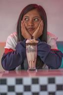 photo of a girl with a milk cocktail in a cafe