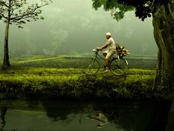 elderly man on an old bike in nature
