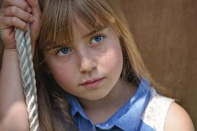 portrait of a pensive girl with freckles