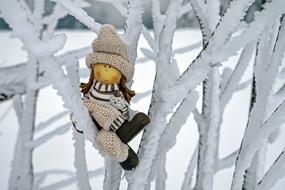 doll on a snowy branch