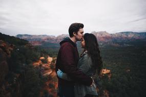 young couple kissing in scenic Highland