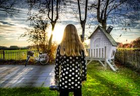 girl and outdoor play house