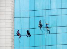for cleaners at work on glass facade, hanoi, vietnam