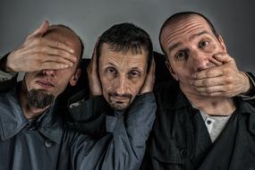 a group of men as a symbol I see nothing, I can not hear, I will not say