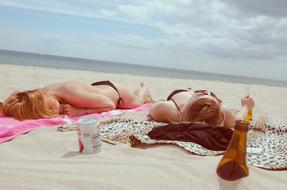 girls resting on the sand beach