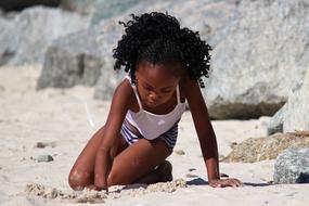 african american girl playing on the beach