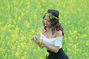 Smiling girl among the yellow flowers