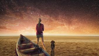 fantastic image of a girl, a wooden boat and a puppy on the beach against the starry sky