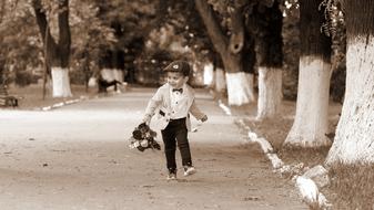 little boy with a bouquet in the park in monochrome