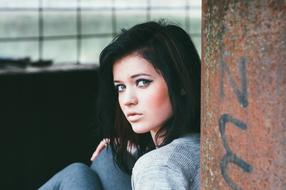 young brunette posing in an abandoned place