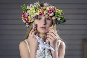 Portrait of pretty young Girl in big colorful Wreath