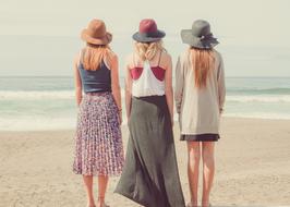 three girls on the beach on the ocean coast