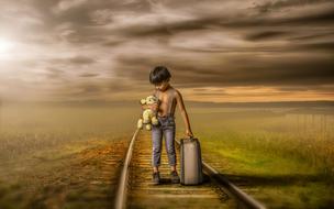 painted boy with a suitcase on the railway