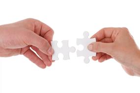 Two white puzzle in hand