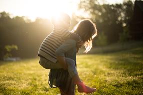 Siblings are playing on a field