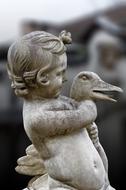 marble statue of boy with a duck