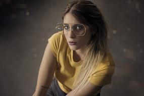 portrait of a girl in a yellow t-shirt and fashionable glasses
