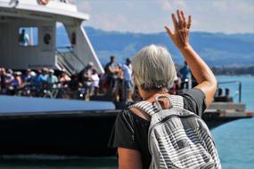 elderly woman meets friends on a ferry