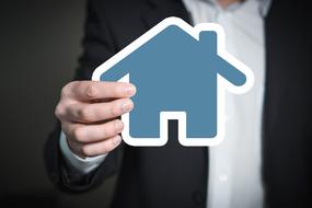 Home icon in male hand