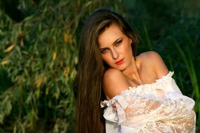 photo of a girl with long hair in a white blouse