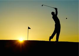 silhouette of a golfer against the evening sky