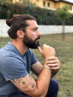 photo of a man with a beard and tattoos