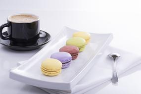 five colorful Macaroons and coffee