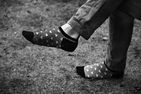 Black and white photo of the feet in patterned socks