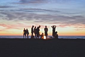 company photo on the beach by the fire