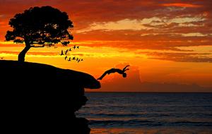 boy jumping from cliff