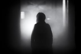 Person in the building with shadows and fog